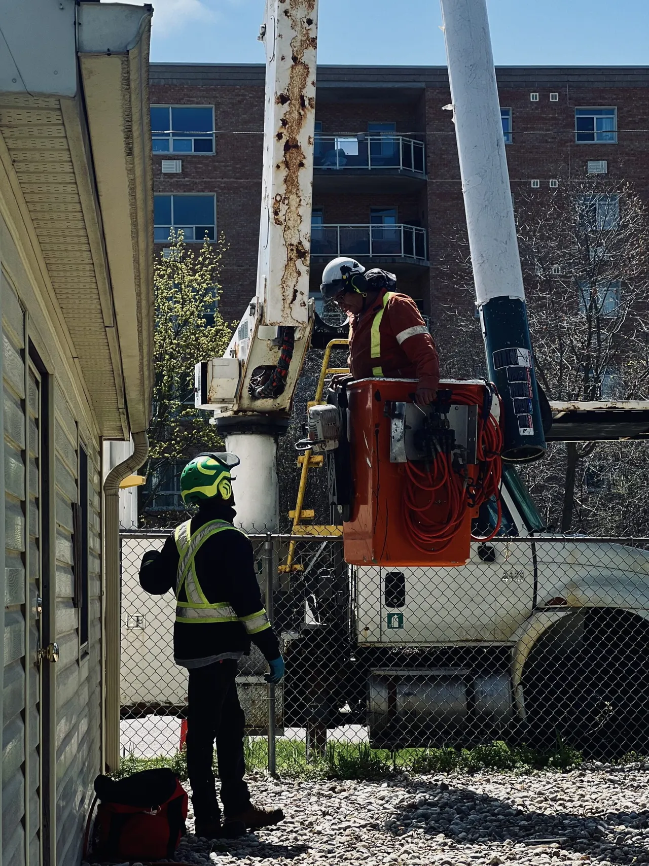 An employee standing in an elevated bucket